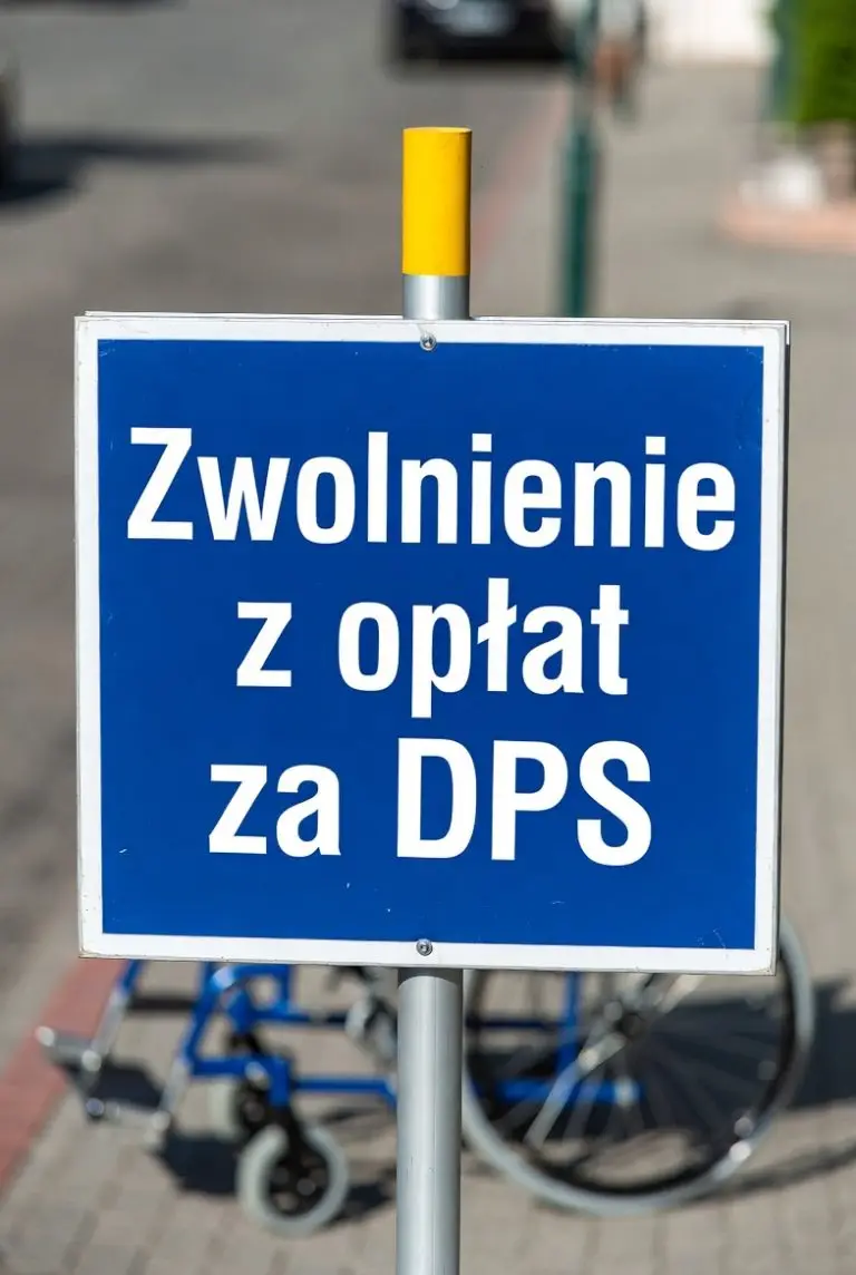 Tablica z napisem zwolnienie z opłat za DPS ustawiona na chodniku przed domem pomocy społecznej
